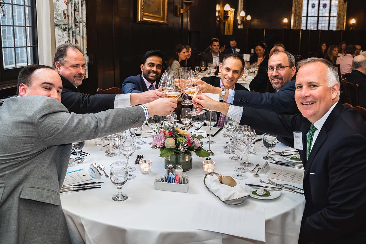 Participants in the national awards presentation dining at a table with their glasses raised together